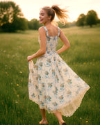 Dear Georgina Arabella Dress – yellow floral midi dress with wide straps, ruched bodice, and lace-trimmed hem, shown in motion in a sunlit meadow, from the English Garden Party collection.