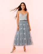 Dear Georgina Ophelia Skirt in Gray – front view of embroidered mesh midi skirt with white floral appliqué and blush lining, styled with a silver satin camisole and metallic heels, from the English Garden Party collection.